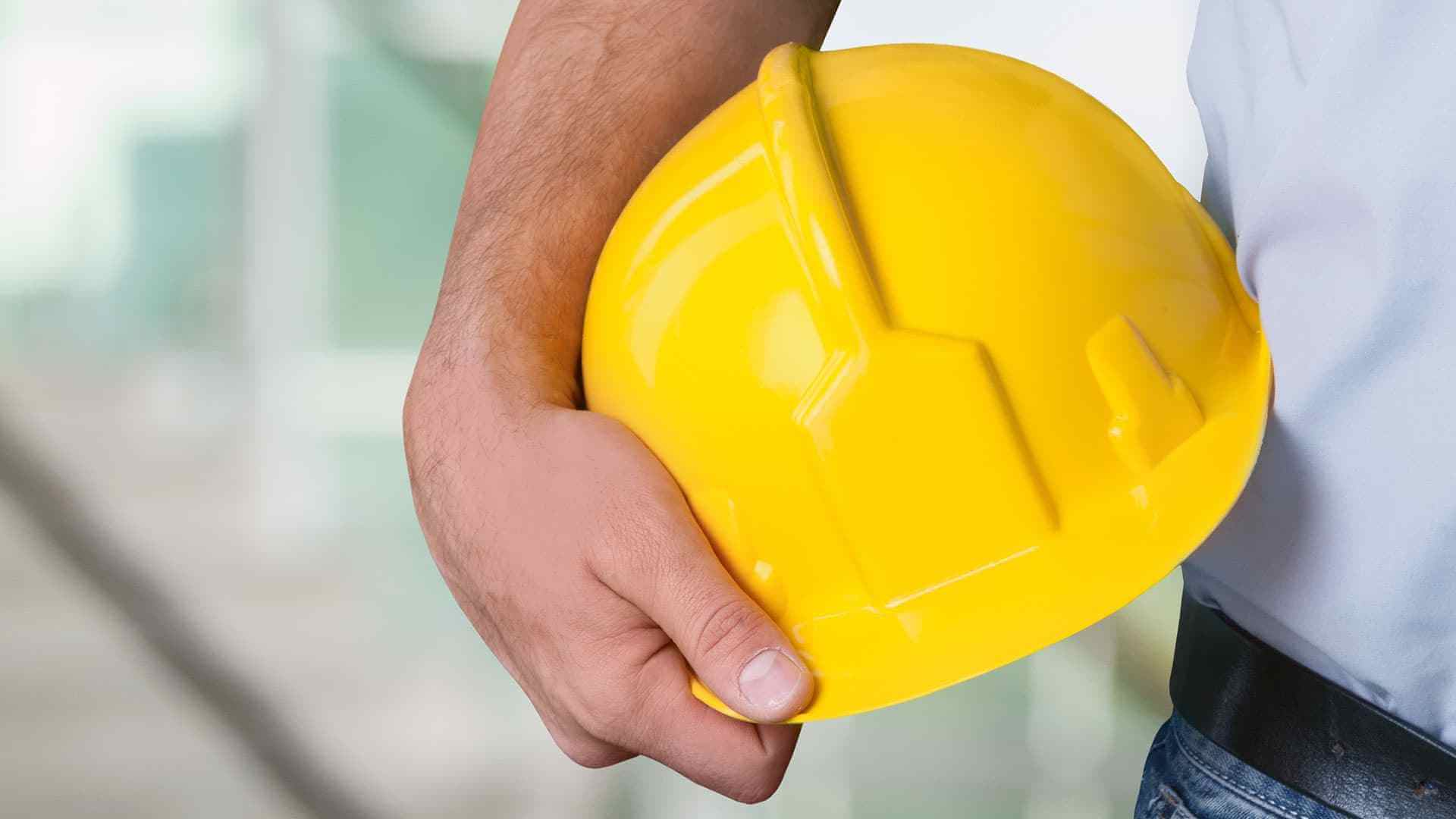 Worker holding a safety helmet